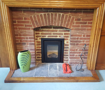 Di Luso R4 Inset Wood Burner - with 3 sided frame in black installed in wonderful, original Arts & Crafts property between Guildford and Leatherhead, Surrey.